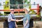 Smiling mature farmer shaking hands with senior famer in field