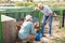 Smiling mature female and male proffesional farmers near chicken house