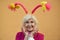 Smiling mature lady with funny headgear stock photo