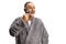 Smiling mature man in a bathrobe using a shaving machine