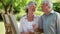 Smiling mature man looking at his wife who is painting