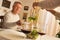 Smiling mature man and woman serving salad