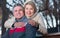 Smiling mature married couple sitting on park bench