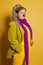 Smiling mature woman clown on yellow background
