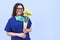 Smiling mature woman doctor nurse with bouquet of flowers, medical worker day, copy space