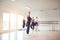 Smiling mature woman doing ballet in a dance studio