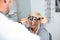 Smiling mature woman having eyesight exam and diopter measurement