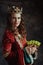 smiling medieval queen in red dress with plate of grapes