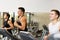Smiling men exercising on treadmill in gym