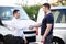 Smiling Men Shaking Hands In Front Cars Damaged After Accident