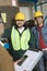 Smiling Men Wearing Hardhats In Factory