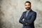 Smiling middle-age Indian high skilled leader in formal suit looks at the camera