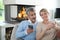 Smiling middle-aged couple using smartphones