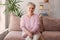 Smiling middle aged mature grey haired woman at home