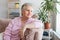 Smiling middle aged mature grey haired woman at home