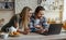 Smiling millennial caucasian man with stubble and lady with credit card shopping online on laptop