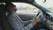 Smiling mixed race businessman surfing social media on his tablet computer sitting inside his car