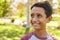 Smiling mixed race Caucasian Asian boy in park looking away