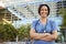 Smiling mixed race female healthcare worker outside hospital