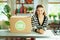 Smiling modern 40 years old housewife in kitchen