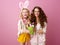 Smiling modern mother and daughter showing Easter eggs bucket