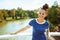 Smiling modern tourist woman on river boat having river voyage