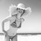 Smiling modern woman in bikini and beach straw hat on seacoast