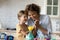 Smiling mom and little daughter play chemistry lab game