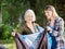 Smiling Mother And Daughter Assembling Tent In