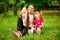 Smiling mother and daughter make selfie on walk in park. Positive. Summer  day.