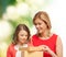 Smiling mother and daughter opening gift box