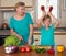 Smiling mother and funny playful daughter cooking together, help children to parents.