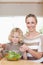 Smiling mother and son stirring salad