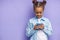 Smiling mulatto child girl with mobile phone in hands, isolated