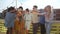 Smiling multi-ethnic friends toasting on the rooftop terrace