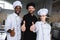 smiling multicultural chefs showing thumbs up