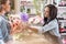 Smiling multiethnic florists working together in flower shop