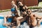 smiling multiethnic friends in swimsuits and sunglasses relaxing