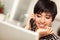 Smiling Multiethnic Woman with Cell Phone, Laptop