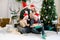 Smiling multiracial boys and girls celebrating Christmas in decorated cozy living room