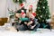 Smiling multiracial boys and girls celebrating Christmas in decorated cozy living room