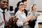 Smiling multiracial businesspeople applauding to speaker