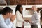 Smiling multiracial businesspeople handshake greeting at meeting