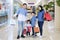 Smiling Muslim family hold shopping bags in mall