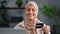 Smiling Muslim shopaholic woman in hijab enjoy online shopping use laptop paying e money credit card