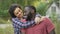 Smiling newly married couple celebrate buying a new cottage in the countryside