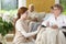 Smiling nurse taking care of disabled senior woman in the nursing house