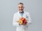 Smiling nutritionist holding fresh vegetables and fruit