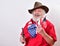 Smiling old cowboy with a pistol in one hand and the American flag in the other