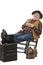 Smiling old cowboy in rocking chair with feet up